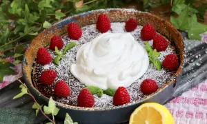 En härlig vegansk kladdkaka med fluffig grädde, färska hallon och myntablad. En perfekt dessert för alla tillfällen.