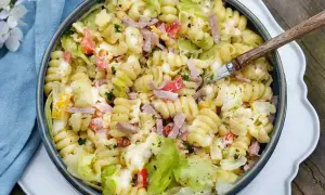Krämig pastasallad med skinka, tomat och sallad. Perfekt dressing till pastasallad för en somrig buffé.