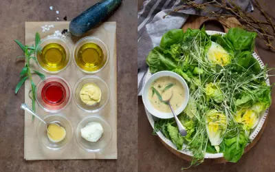 Ingredienser för dressing till sallad: olivolja, vinäger, senap, majonnäs och örter. En fräsch sallad med gröna blad och groddar.