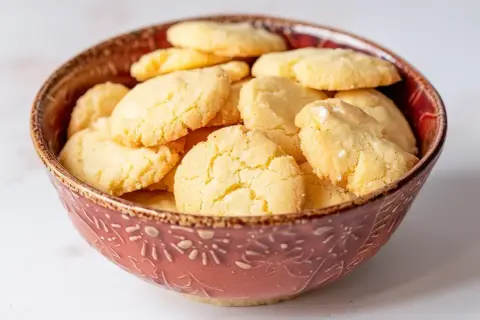 En skål fylld med hembakade hallongrottor. Perfekt för fika, här är ett enkelt hallongrottor recept.