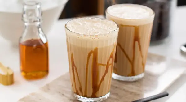 Två glas med karamellfrappe, redo att avnjutas. Ett enkelt frappe recept för en svalkande dryck.