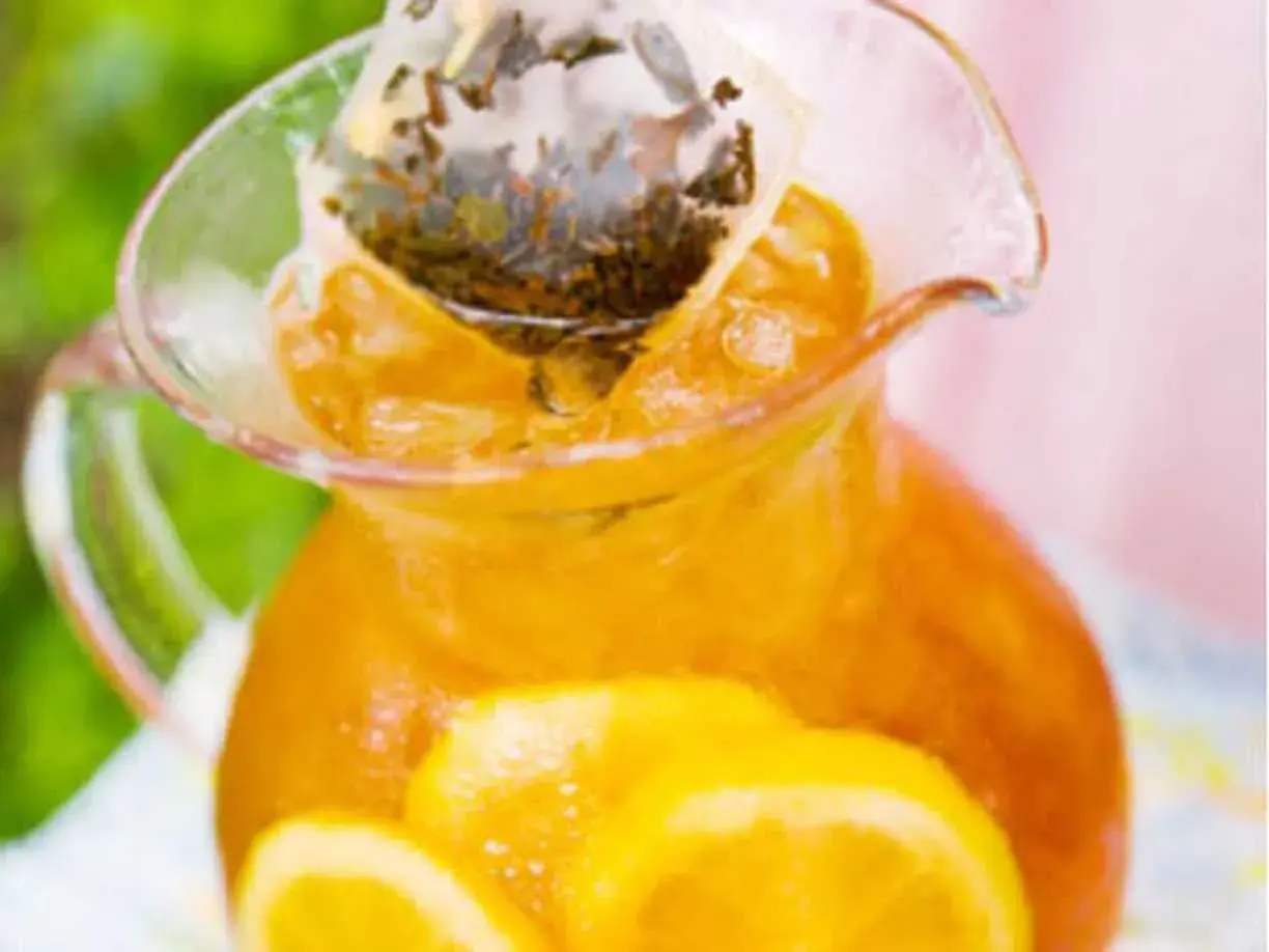 En karaff med iste, citronskivor och en tepåse som drar. Perfekt iste recept för en varm sommardag.