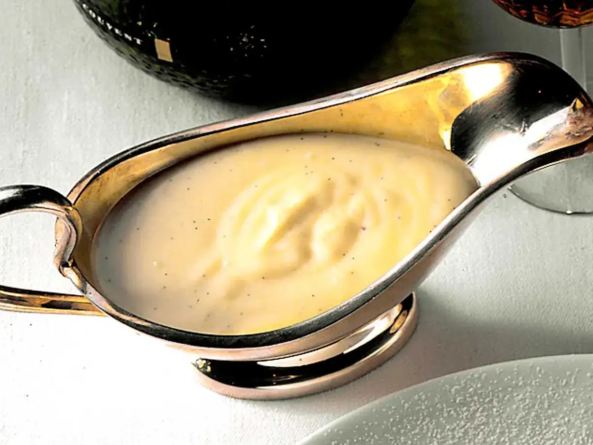 Krämig vaniljsås i ett silverfat, perfekt för ditt vaniljsås recept. Smakrik och len.