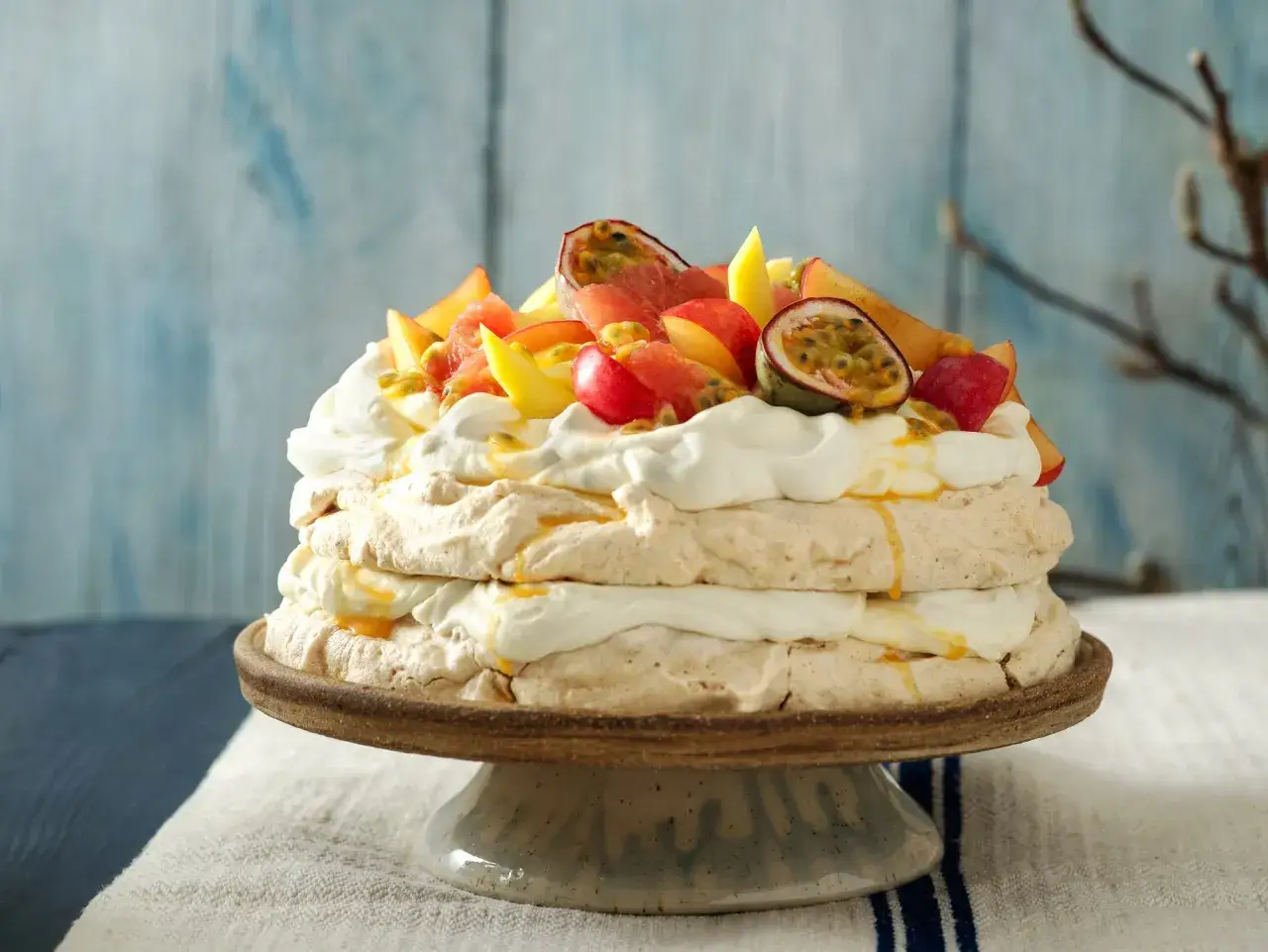 En vacker pavlova med vispgrädde och färsk frukt, perfekt för ett somrigt pavlova recept.